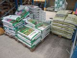a large pile of bags of cement on a pallet