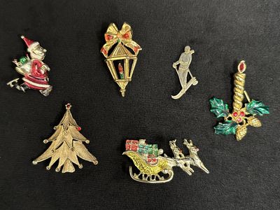 six different christmas ornaments on a black surface
