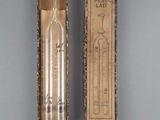 an old box with a thermometer sitting on top of a table