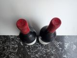 two bottles of wine that are sitting on a table