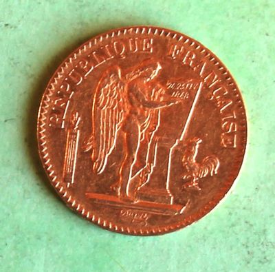 a close up of a penny on a table with a green background