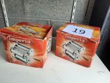 two boxes of imperia pasta sitting on a table next to each other