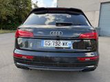 the rear end of a black audi suv parked in a parking lot