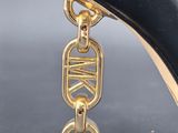the heel of a pair of black high heeled shoes with a gold chain attached to it