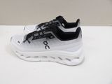 the white and black sneakers are sitting on a white surface