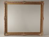 an ornate gold framed mirror against a white background