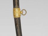 a gold and black dagger with a gold handle