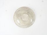 a white bowl on a white surface with a white background