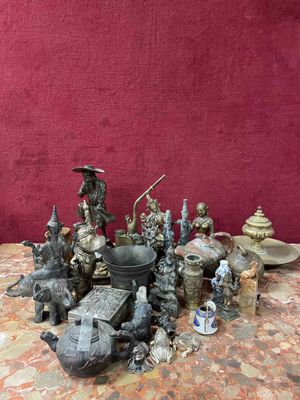 many figurines sitting on a table with a red background
