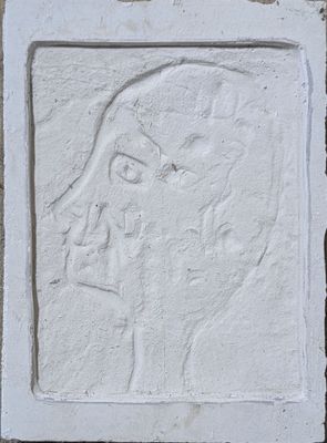 a close up of a white relief of a woman ' s face