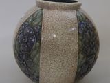 a ceramic vase with a blue and green design on it