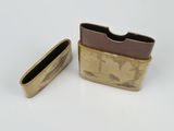 a small gold cigarette case with a cigarette in it