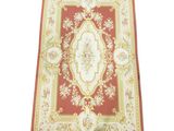 une photo d'un tapis rouge et or orné d'un motif floral