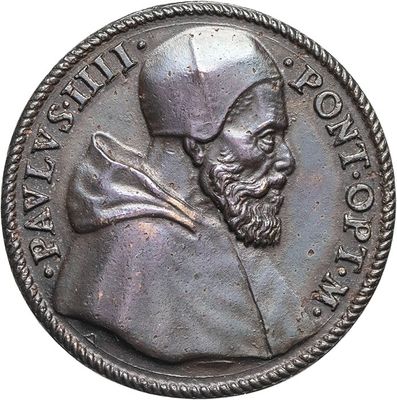 an old silver coin with a man in a hat and a beard