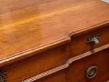 a wooden dresser with many drawers and knobs on it