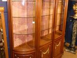 a large display cabinet with a glass door in a room