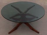 a glass table with wooden legs and a glass top