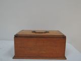 a small wooden box with a handle on it