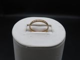 a close up of a gold ring on a white ring stand