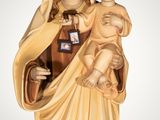 a statue of a woman holding a baby wearing a crown