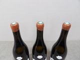 three bottles of wine sitting on top of a table next to each other