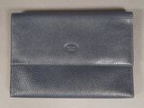 a black leather wallet sitting on top of a table