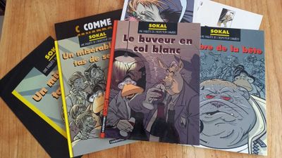 several books on a table with one of the covers pulled up