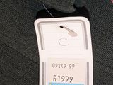 a tag on a black sweater that says c