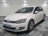 the white volkswagen golf is parked on a checkered tile floor