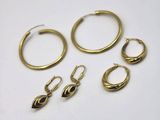 three pairs of gold hoop earrings and a pair of gold hoop earrings