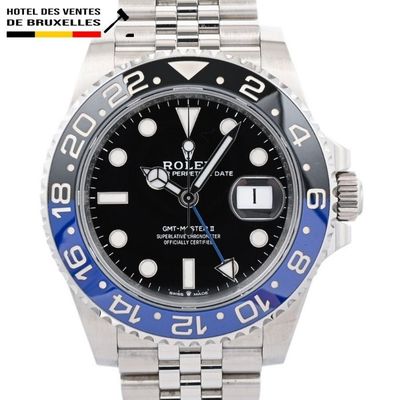 a close up of a wrist watch with a blue bezel