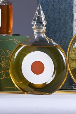 two bottles of olive oil and a bottle of honey on a table