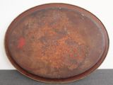 a brown plate with rust on it sitting on a table