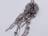 a close up of a silver necklace with spikes and chains