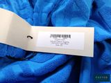 the label is on the blue fabric with a barcode on it