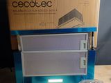 a box with a light on it sitting on a table next to a pair of scissors
