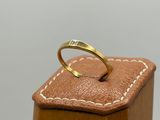 an image of a gold ring sitting on top of a wooden box