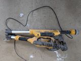 an image of a corded drill on a concrete floor
