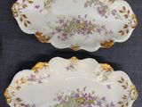 three plates with flowers on them on a table