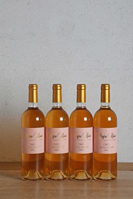 four bottles of wine sitting on top of a wooden table