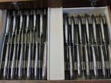 a lot of silver spoons in a wooden box