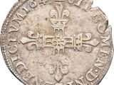 an old silver coin with a cross on it