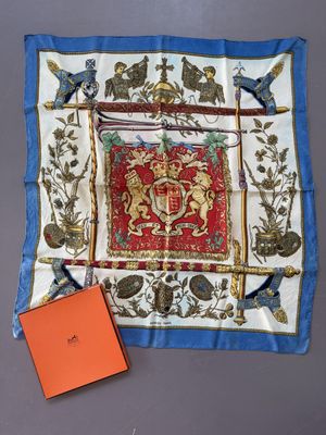 a close up of a square scarf with a red and blue design