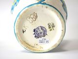 a blue and white vase with a picture of a bird on it
