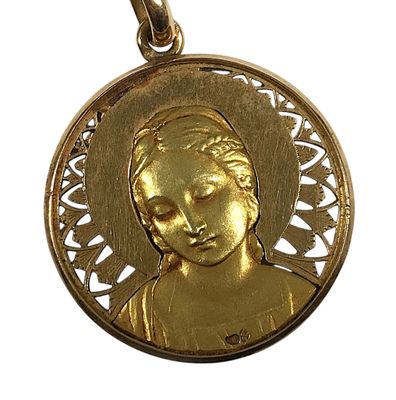 an image of a gold pendant with a woman ' s face in the center
