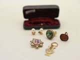 an assortment of rings and earrings in a case on a table