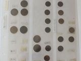a lot of coins on a table with a lot of stickers on it