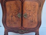 a wooden cabinet with a clock on top of it