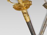 two swords with a gold handle and a silver handle