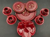 a picture of a set of red dishes and cups